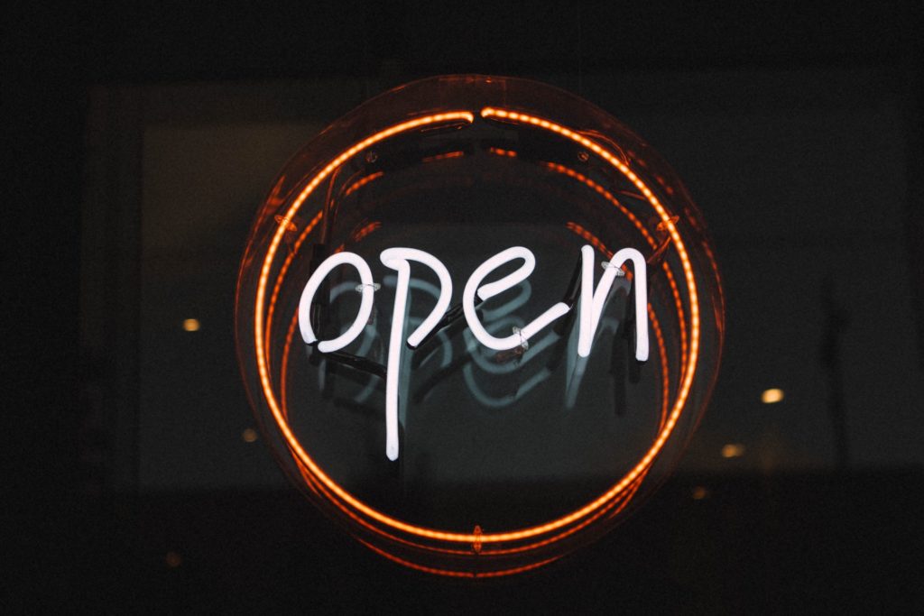 illuminated sign that writes the word open 