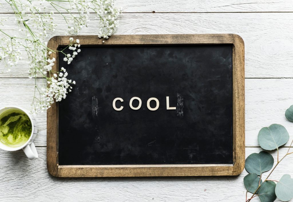 the word cool is written on a chalkboard 