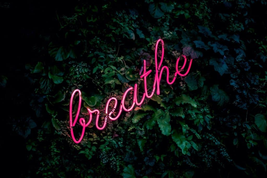 illuminated sign that writes the word breathe 