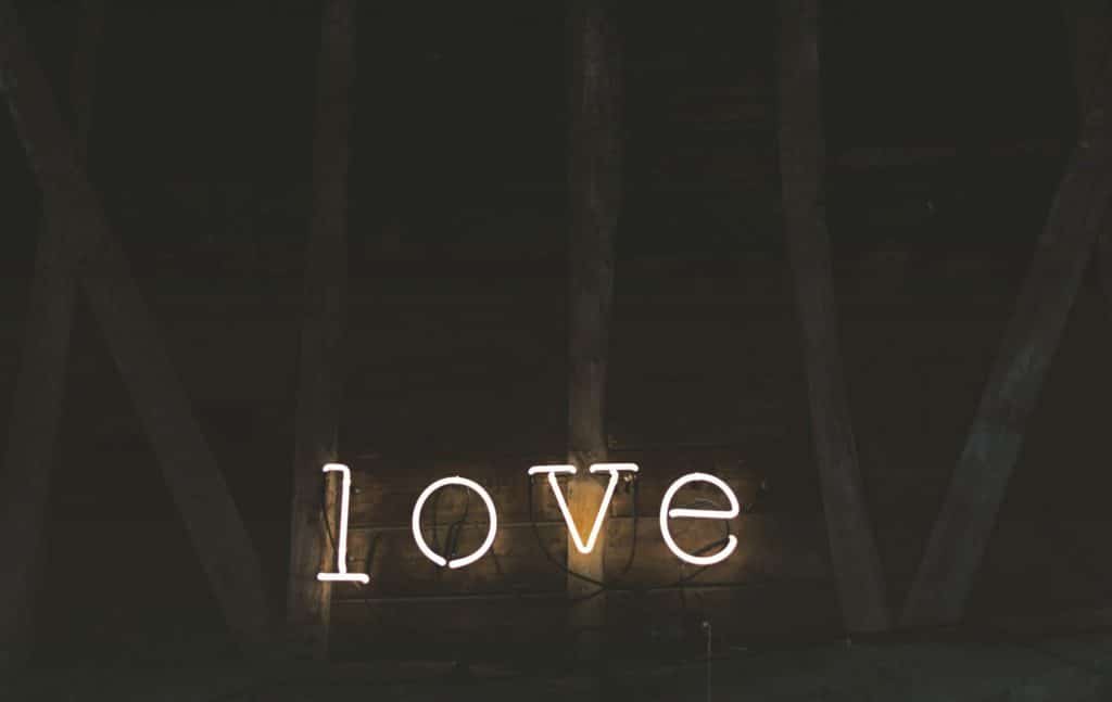 Illuminated sign that writes the word love 