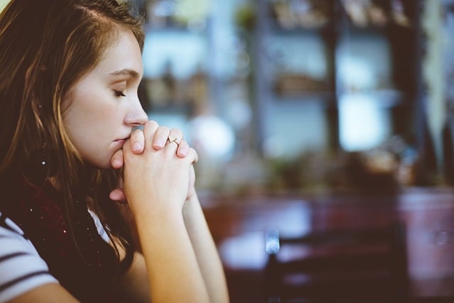 close-up photo of a woman praying