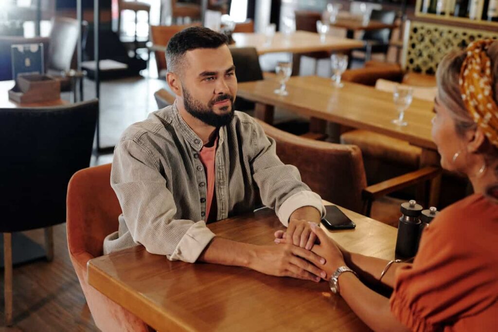 couple holding hands inside a restaurant