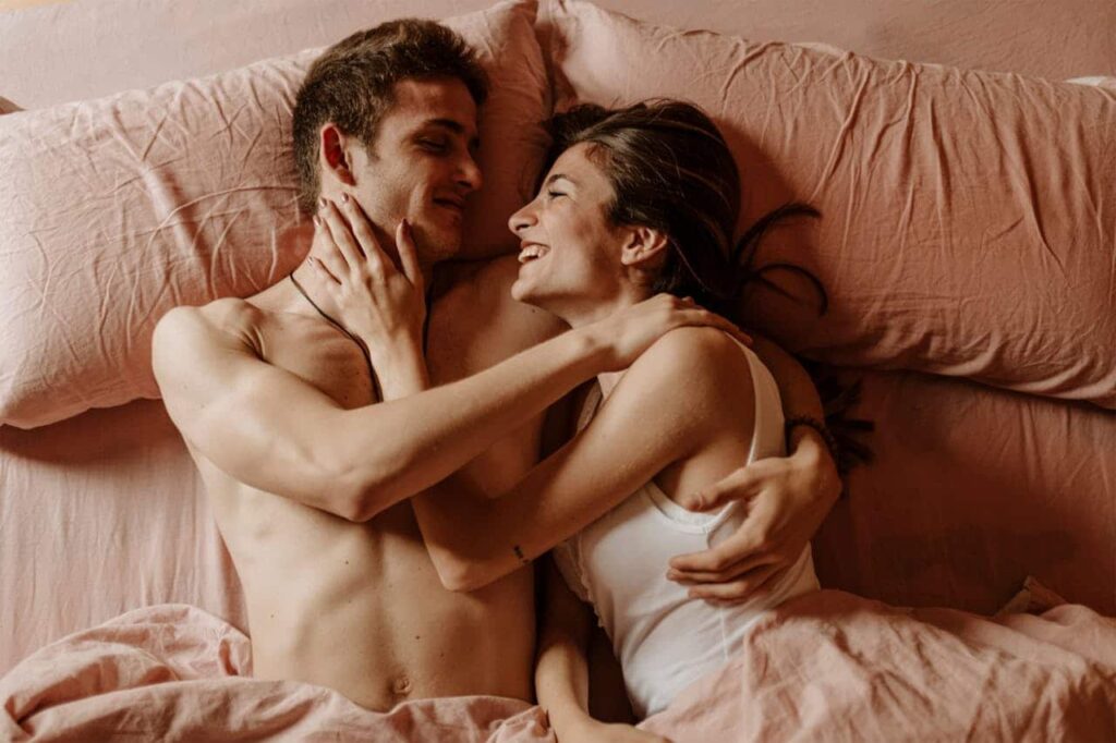 couple lying down on the bed together