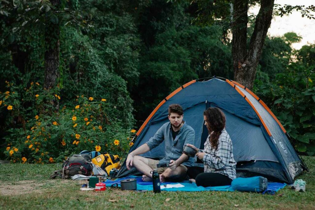 couple relaxing near tent