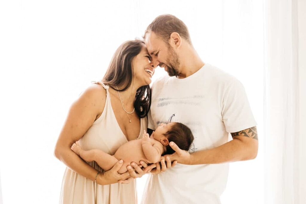 happy couple carrying a baby