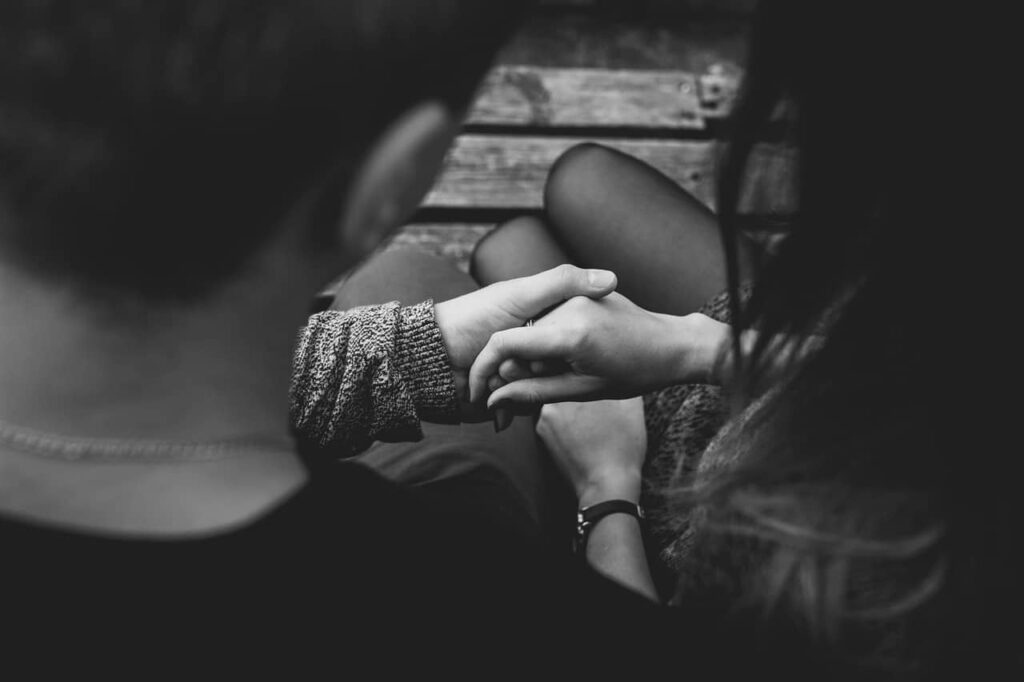 man holding the hand of his woman