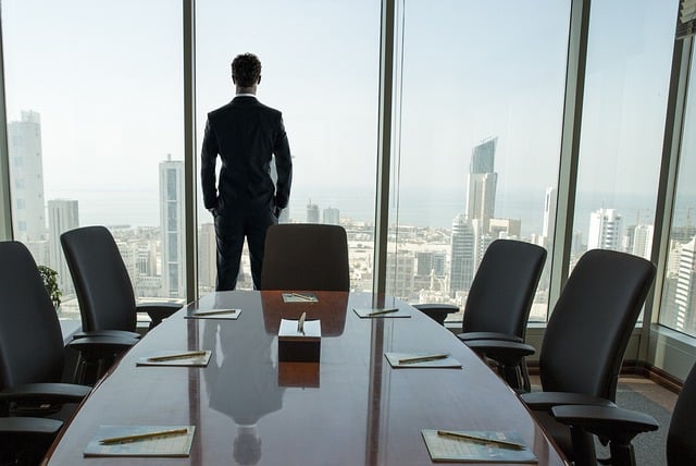 Man in suit looking out the window