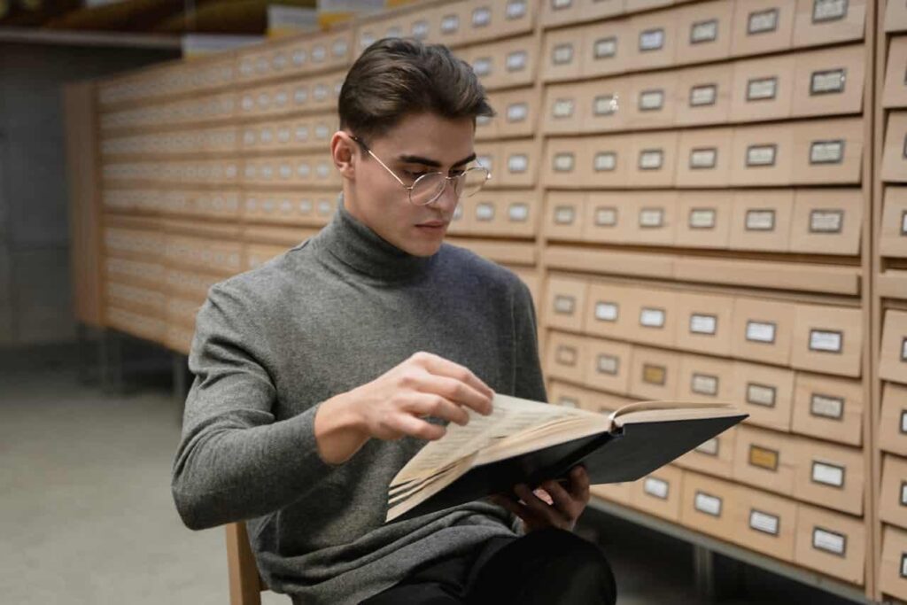 man reading a book in library