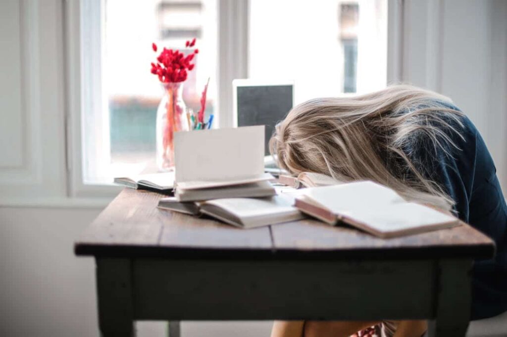 overwhelmed woman leaning on table