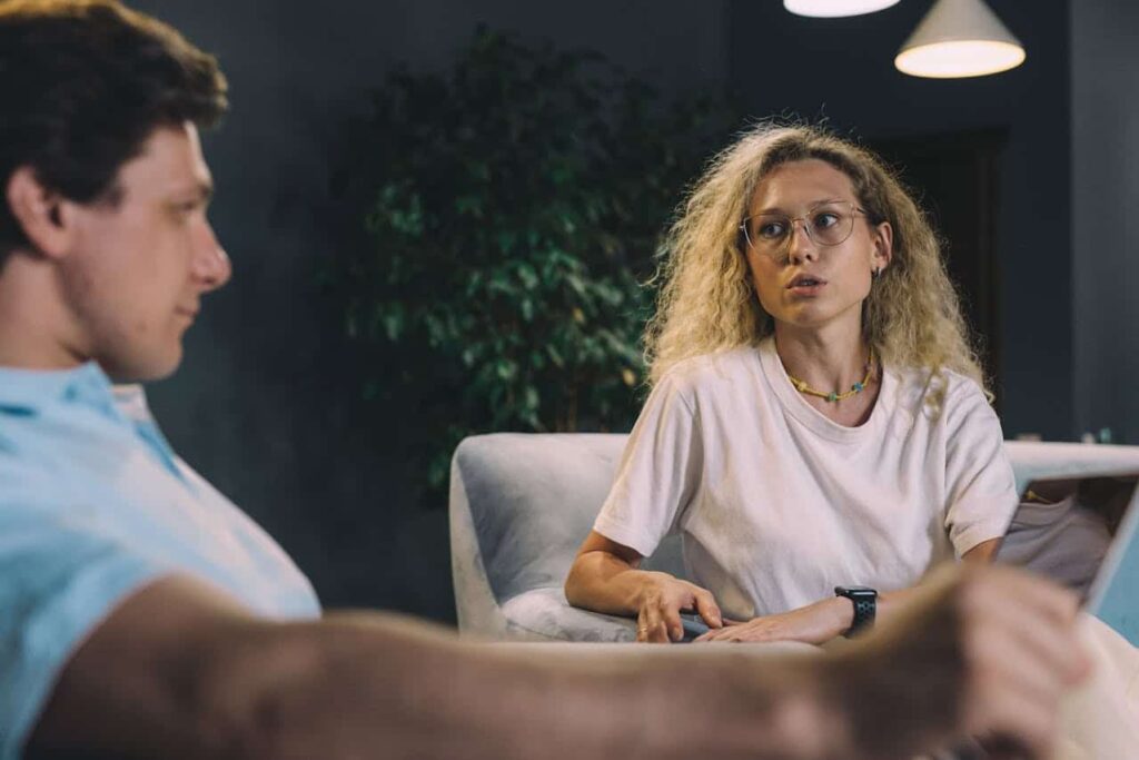 woman in white shirt talking to her man