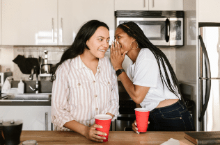 woman whispering to her friend