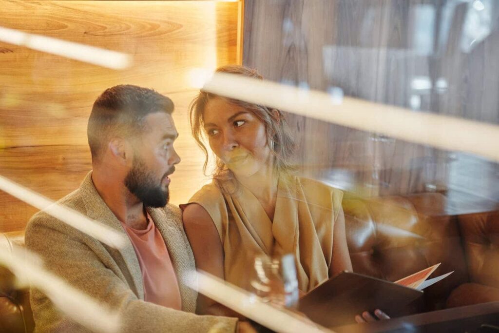 couple studying menu at restaurant table