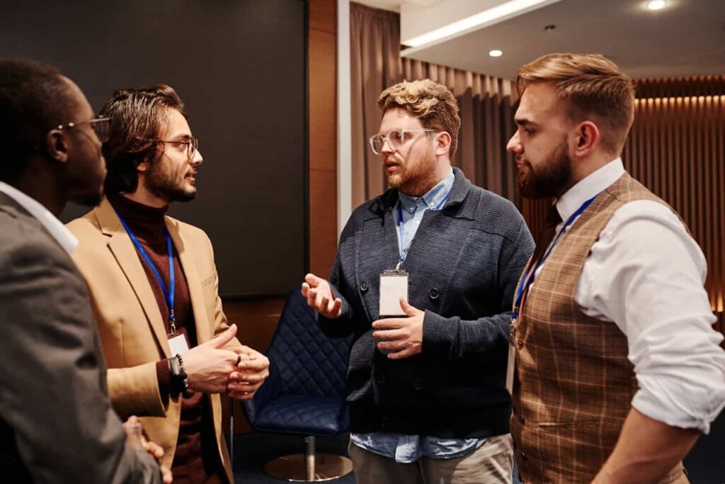 men having a discussion at an event
