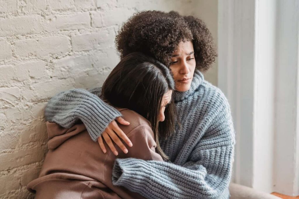 woman comforting her friend