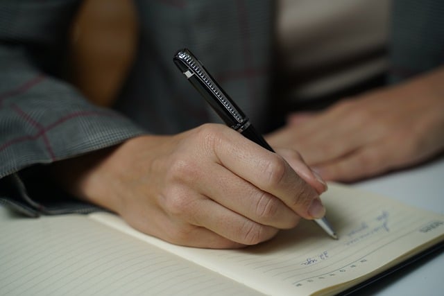 writing on notebook