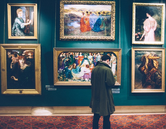 a man appreciating artwork in a museum