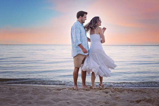 couple enjoying beach during sunset