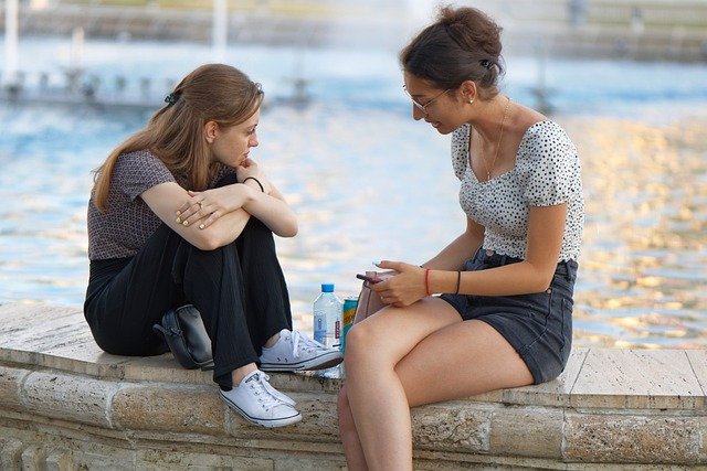 woman giving an advice to her friend