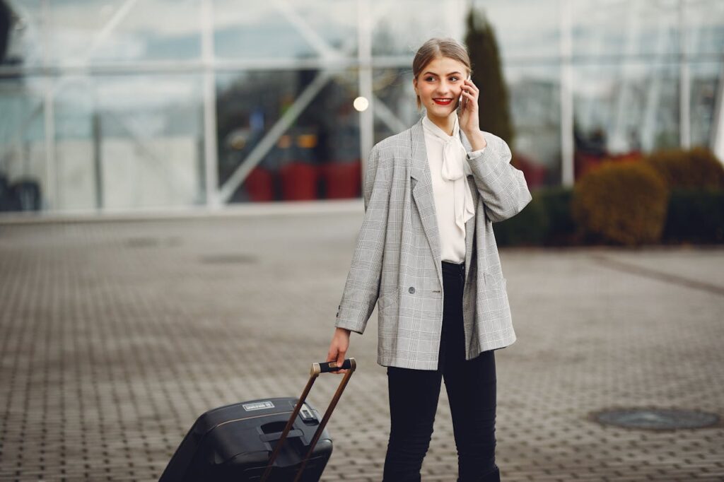 female traveler on phone with luggage
