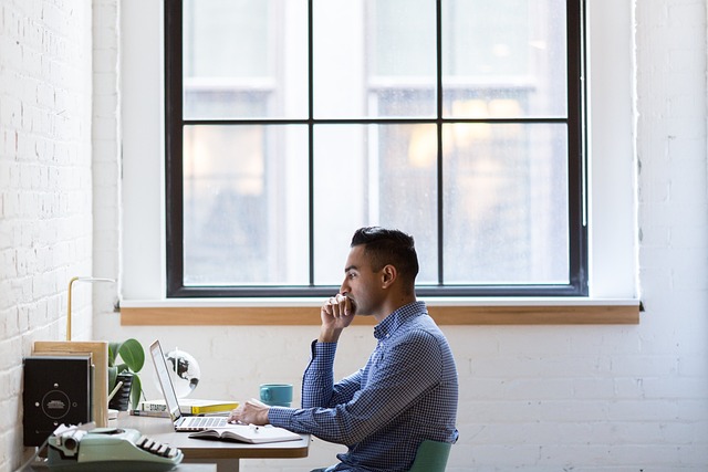 man conducts research and analysis at a desk