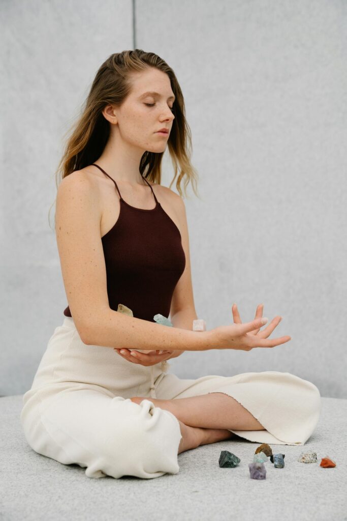 woman meditating with crystals