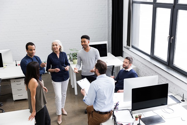 colleagues engaged in conversation in an office setting