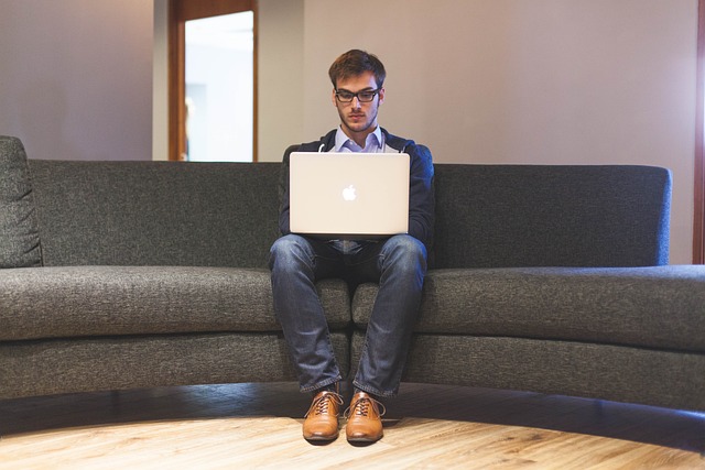 man focused on working on a laptop