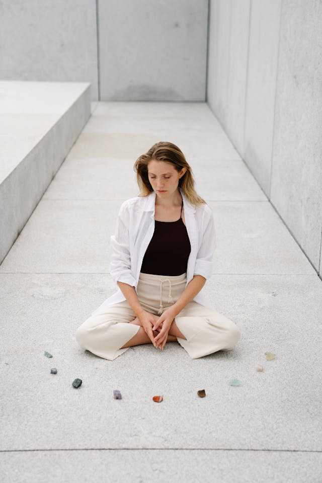 woman meditating with crystals