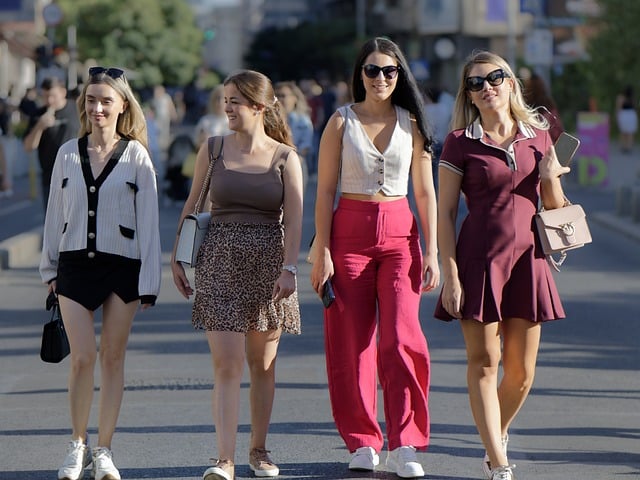 women strolling together down the street