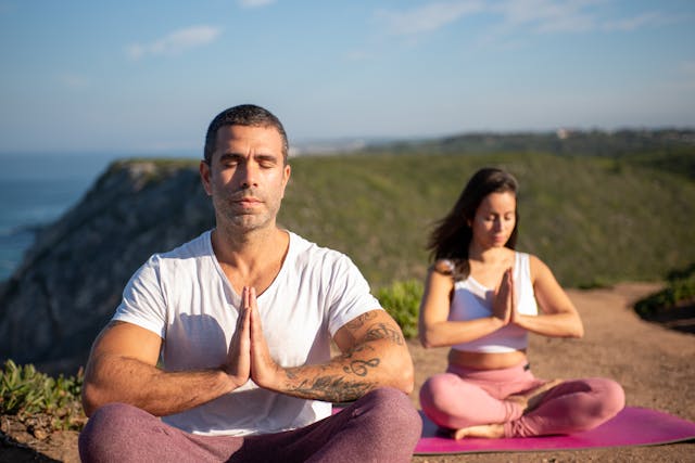 a man and a woman meditating together