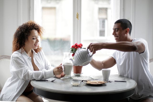 a man pouring hot water into his partner's cup