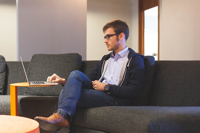 a man focused on working on a laptop