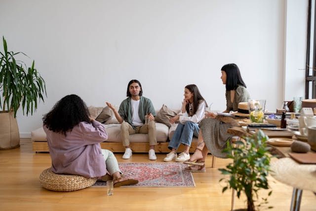 group of friends talking in a living room