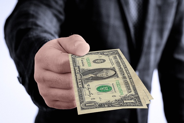 hand giving money