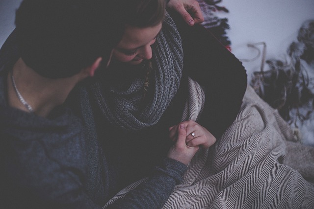 couple cuddles under cozy blanket
