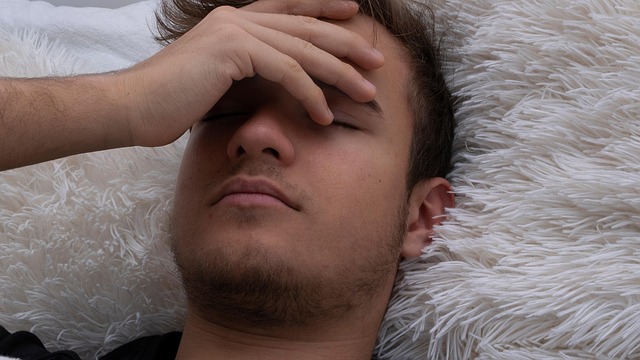 a boy lying down while having a fever