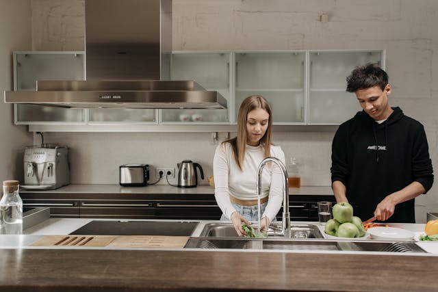 a couple helping each other prepare food