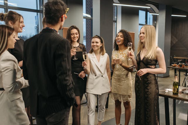 a group of people celebrating with wine in their hands