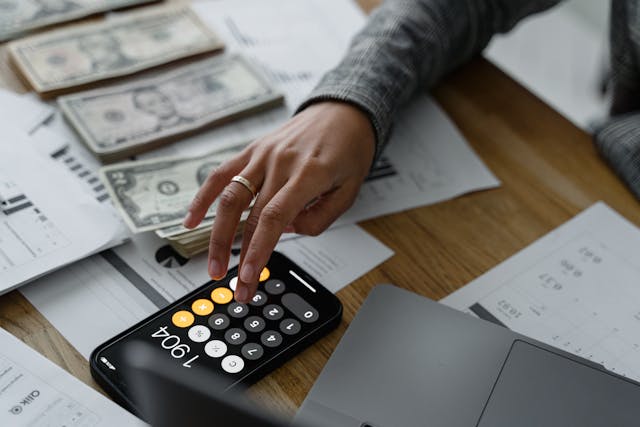 a person using a calculator to manage finances