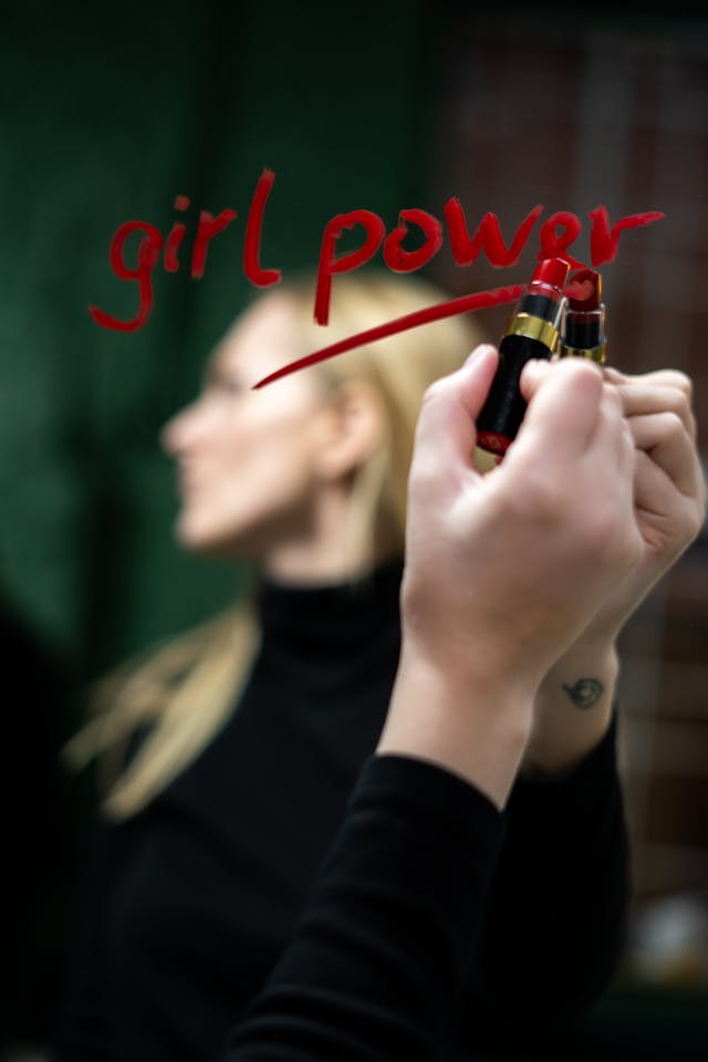 girl power written on the mirror using red lipstick