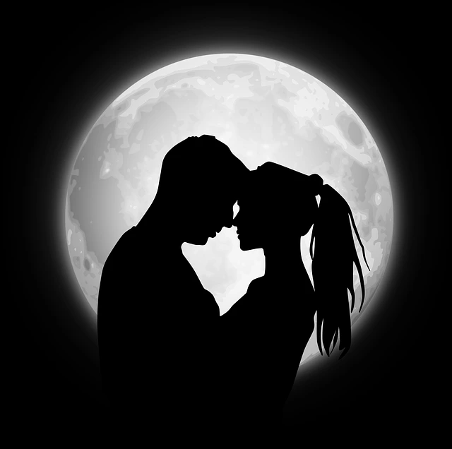 silhouette of a couple embracing before a large glowing full moon | Trusted Astrology