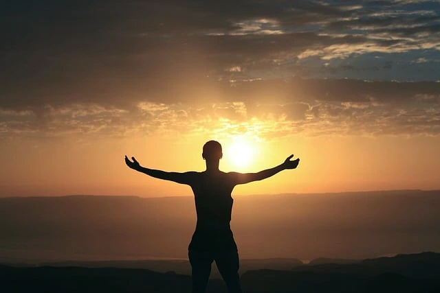 Silhouette of a person with open arms at sunrise | Trusted Astrology