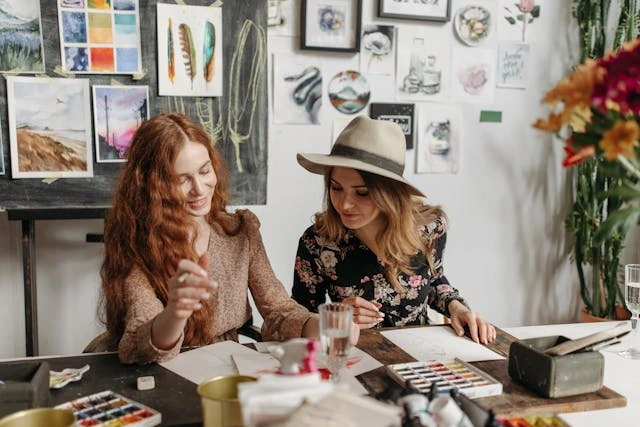 Two women friends creating watercolor art | Trusted Astrology